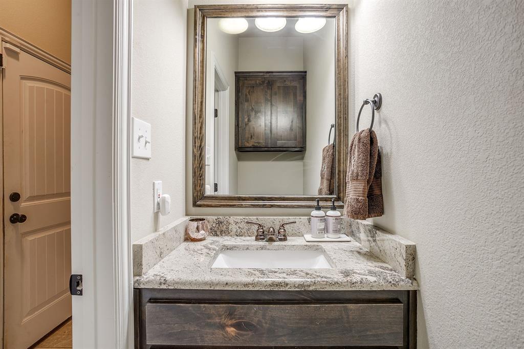 7320 Spring Ranch Court Godley, TX 76044 - Photo 37 of 40 a bathroom with a granite countertop sink and a mirror
