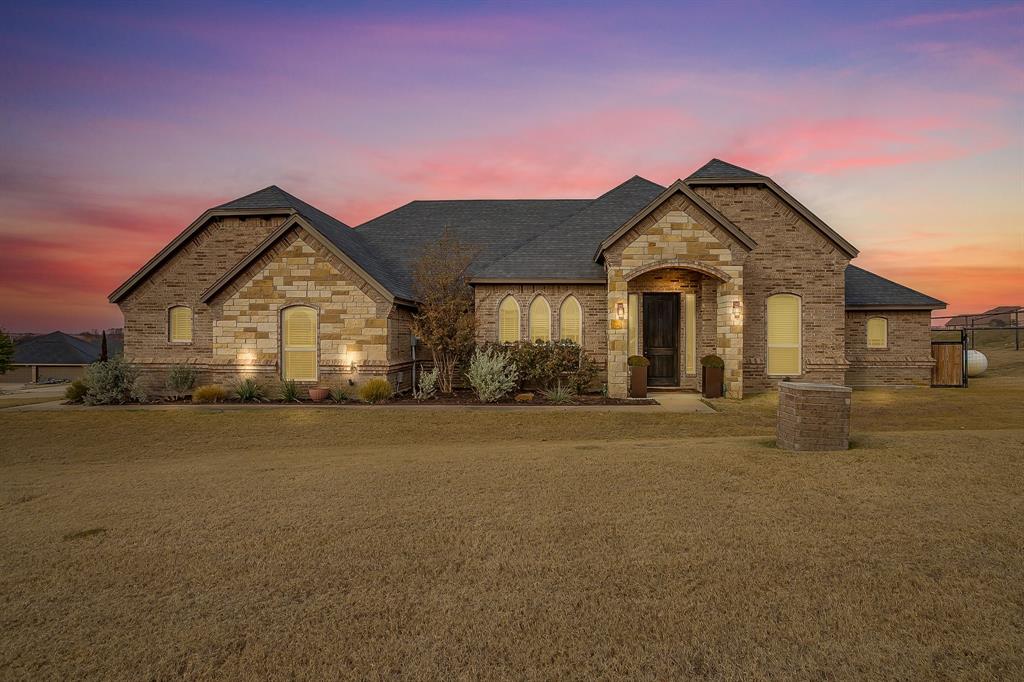 7320 Spring Ranch Court Godley, TX 76044 - Photo 40 of 40 a front view of a house with a yard and garage