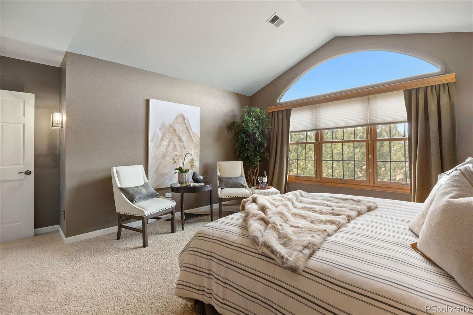 10 Roder Gate Lane Castle Pines, CO 80108 - Photo 14 of 32 a bedroom with a bed and a large window
