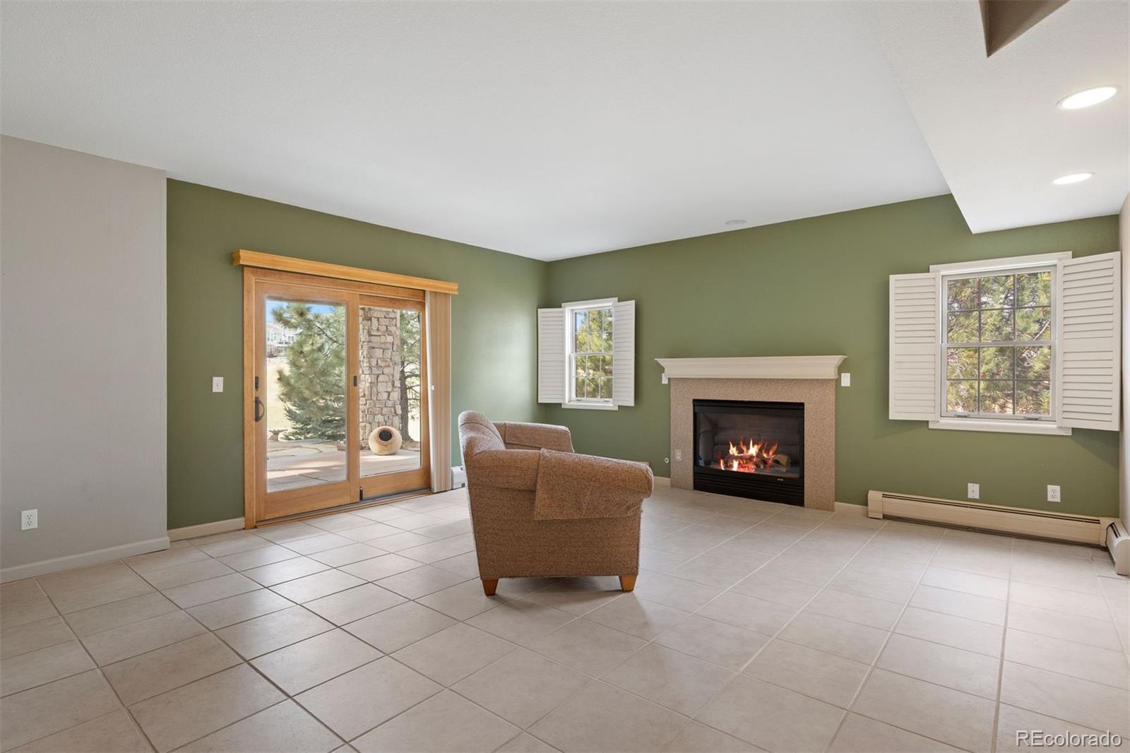 10 Roder Gate Lane Castle Pines, CO 80108 - Photo 18 of 32 a living room with furniture and a fireplace