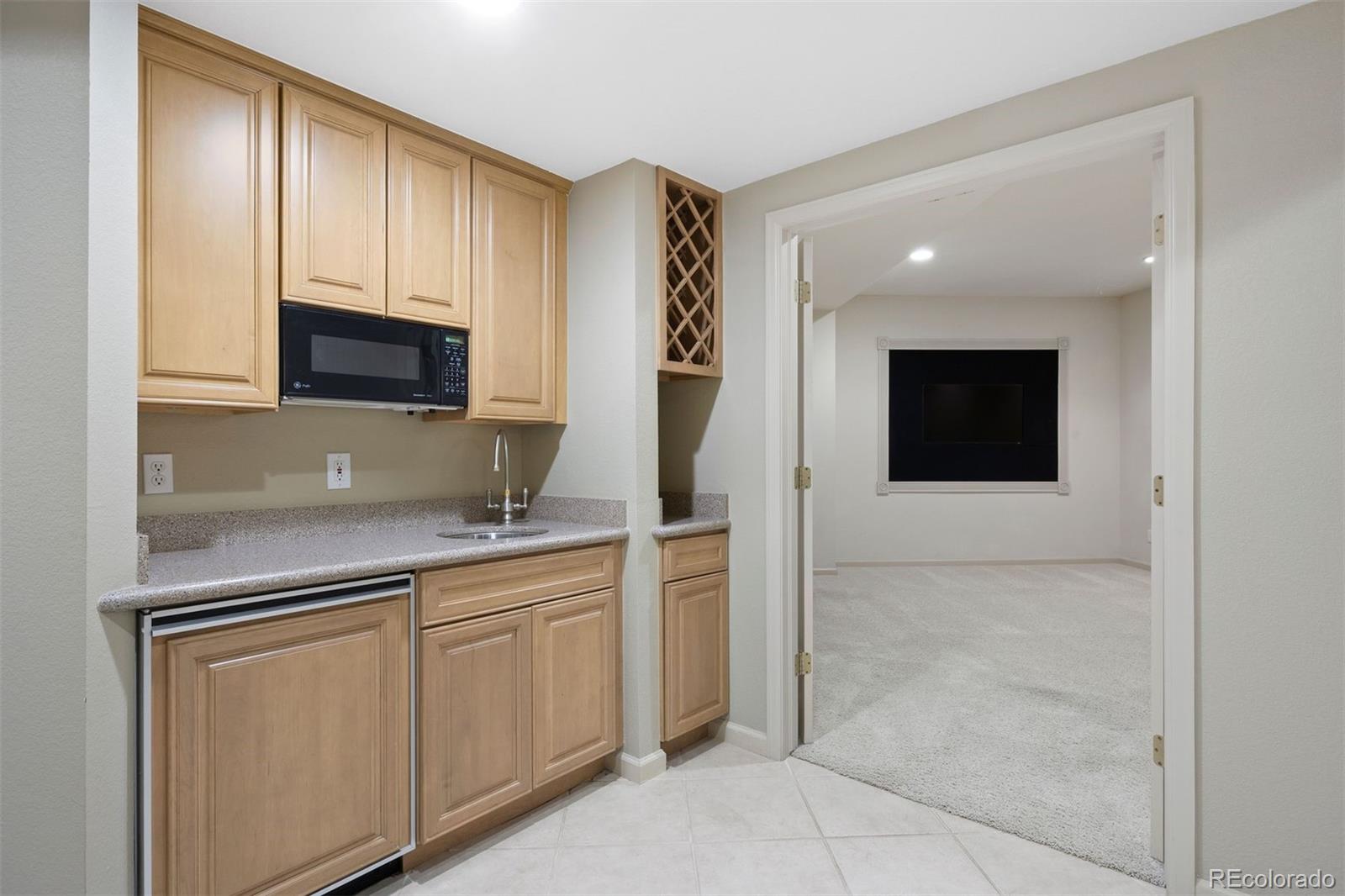 10 Roder Gate Lane Castle Pines, CO 80108 - Photo 20 of 32 a kitchen with a sink and cabinets