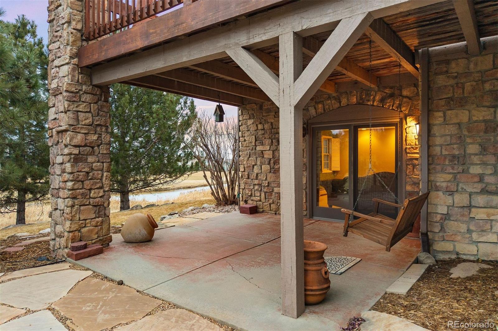 10 Roder Gate Lane Castle Pines, CO 80108 - Photo 27 of 32 a view of a porch with furniture and a yard
