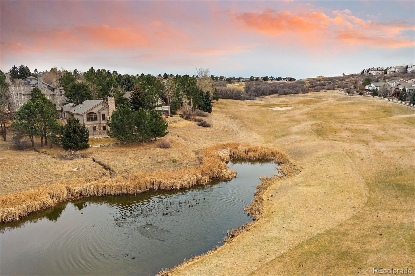 10 Roder Gate Lane Castle Pines, CO 80108 - Photo 4 of 32 a view of a lake with a mountain