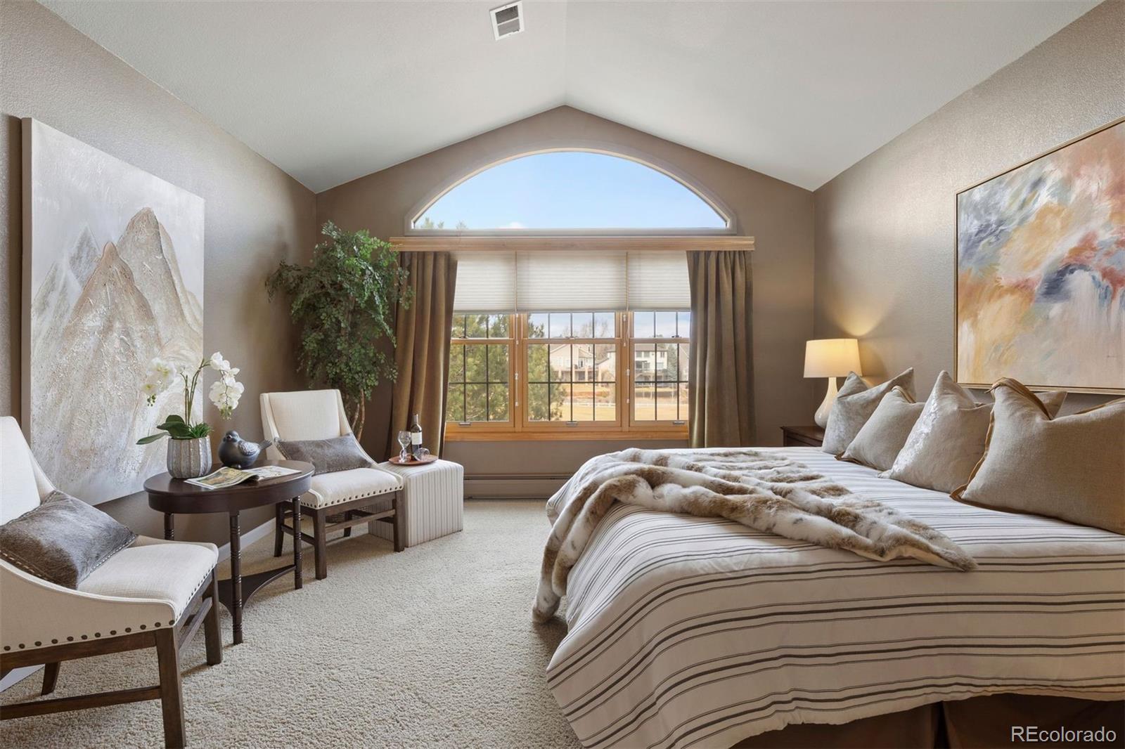 10 Roder Gate Lane Castle Pines, CO 80108 - Photo 5 of 32 a bedroom with bed and large windows