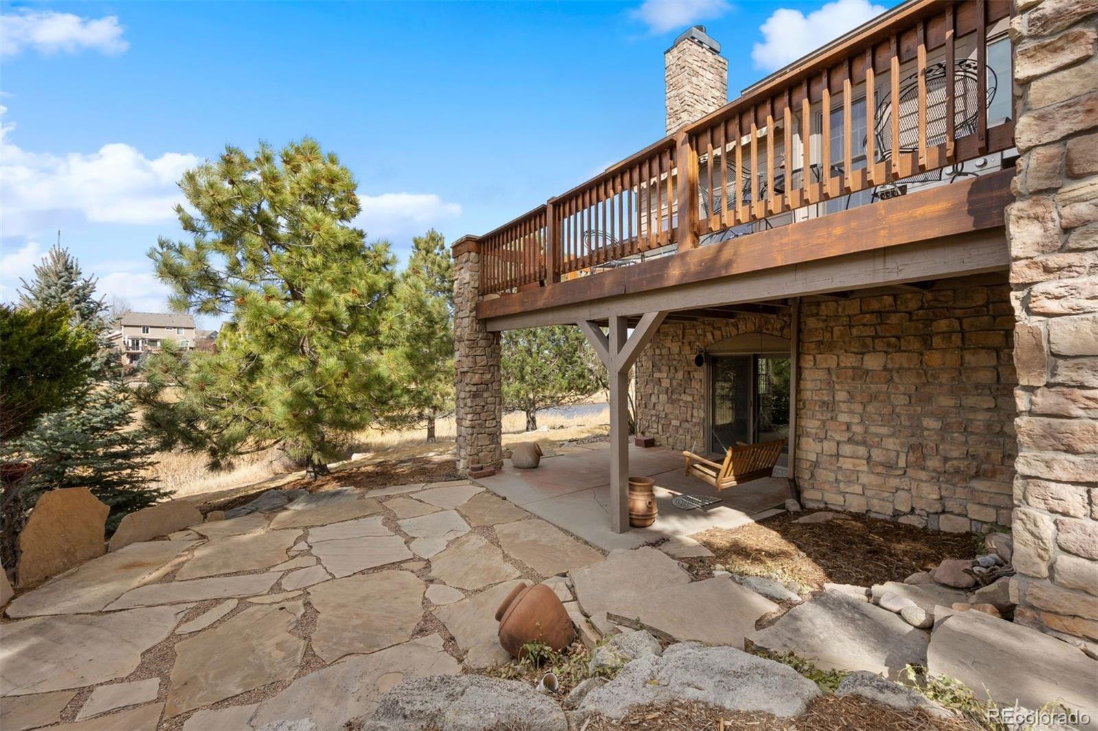 10 Roder Gate Lane Castle Pines, CO 80108 - Photo 7 of 32 a backyard of a house with a yard and seating space