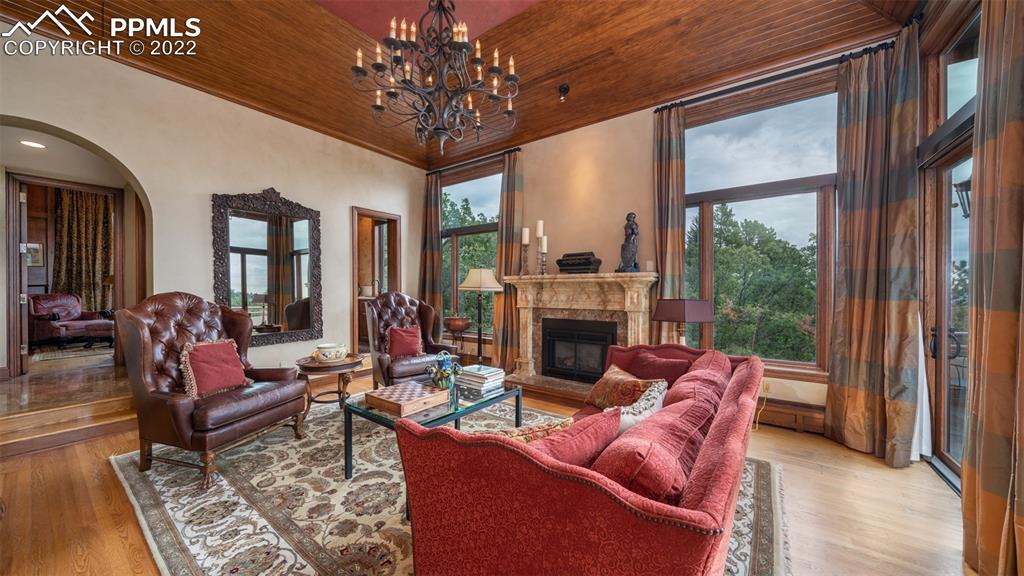 105 Marland Road Colorado Springs, CO 80906 - Photo 11 of 50 a living room with furniture a chandelier and a fireplace