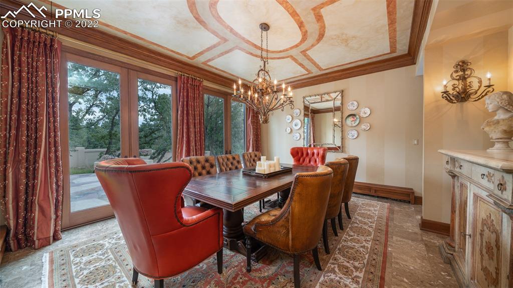 105 Marland Road Colorado Springs, CO 80906 - Photo 13 of 50 a dining room with furniture a chandelier and wooden floor