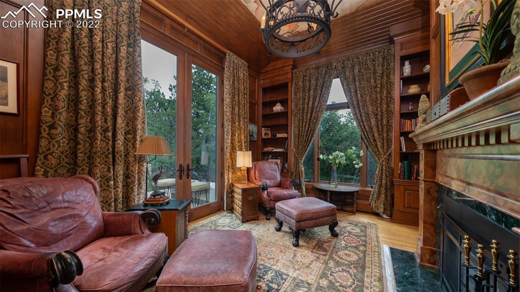 105 Marland Road Colorado Springs, CO 80906 - Photo 14 of 50 a living room with furniture a fireplace and a large window