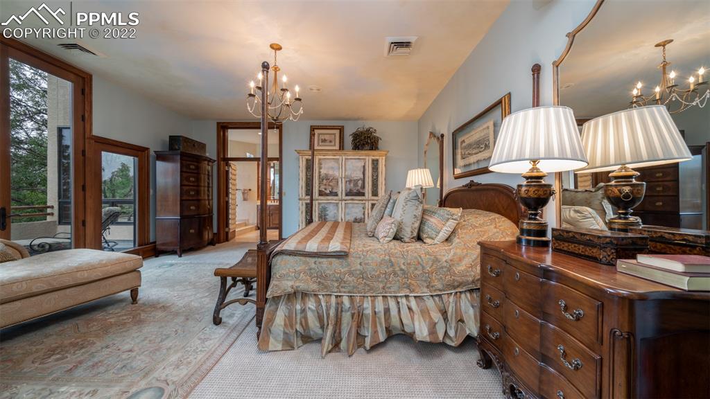105 Marland Road Colorado Springs, CO 80906 - Photo 16 of 50 a living room with furniture a chandelier and a fireplace