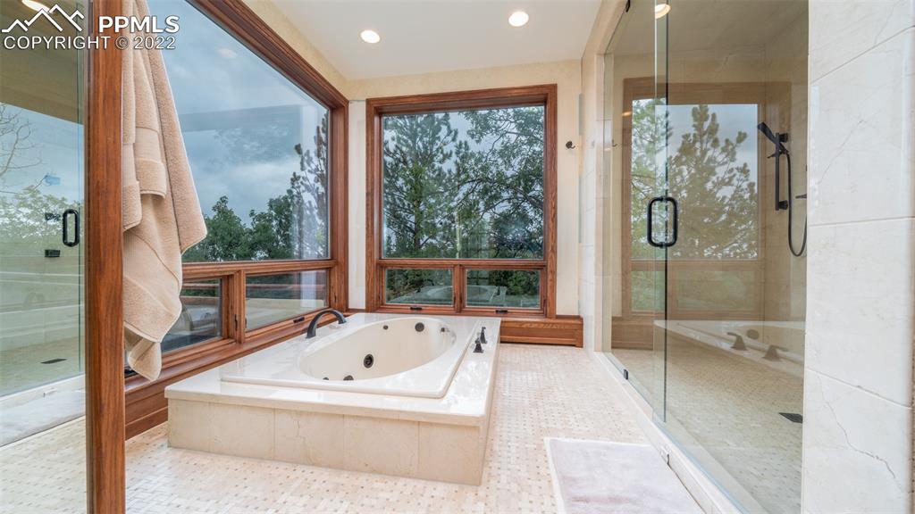 105 Marland Road Colorado Springs, CO 80906 - Photo 18 of 50 a en suite bathroom with a tub shower and window