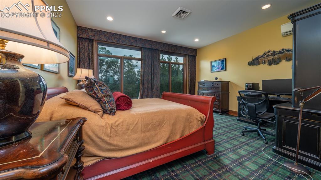 105 Marland Road Colorado Springs, CO 80906 - Photo 27 of 50 a bedroom with a bed and wooden floor
