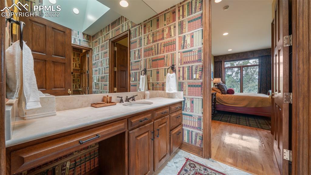 105 Marland Road Colorado Springs, CO 80906 - Photo 28 of 50 a en suite bathroom with a granite countertop sink and a large mirror