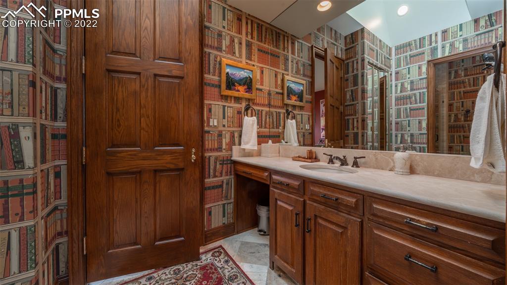 105 Marland Road Colorado Springs, CO 80906 - Photo 29 of 50 a bathroom with a double vanity sink a and a mirror