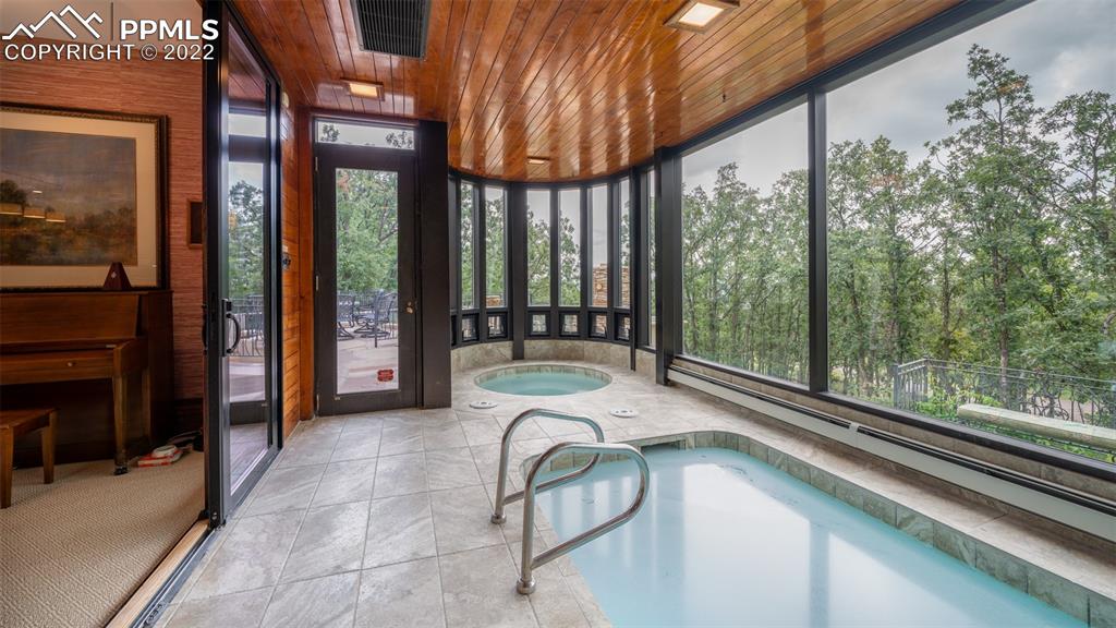 105 Marland Road Colorado Springs, CO 80906 - Photo 33 of 50 a bedroom with a bed and large windows