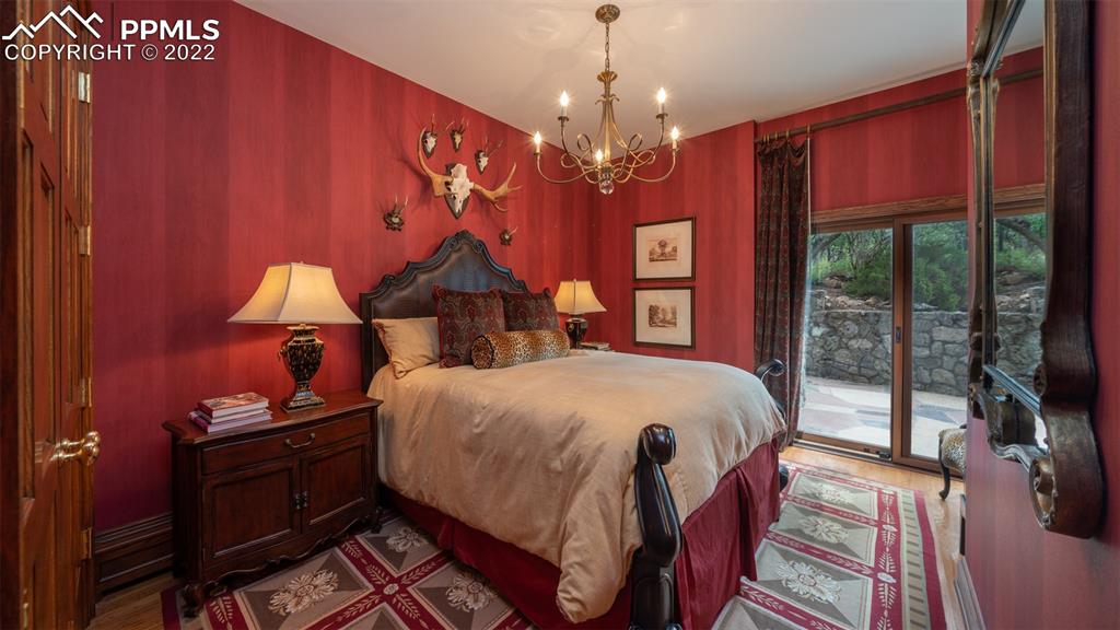 105 Marland Road Colorado Springs, CO 80906 - Photo 38 of 50 a bedroom with a bed and wooden floor