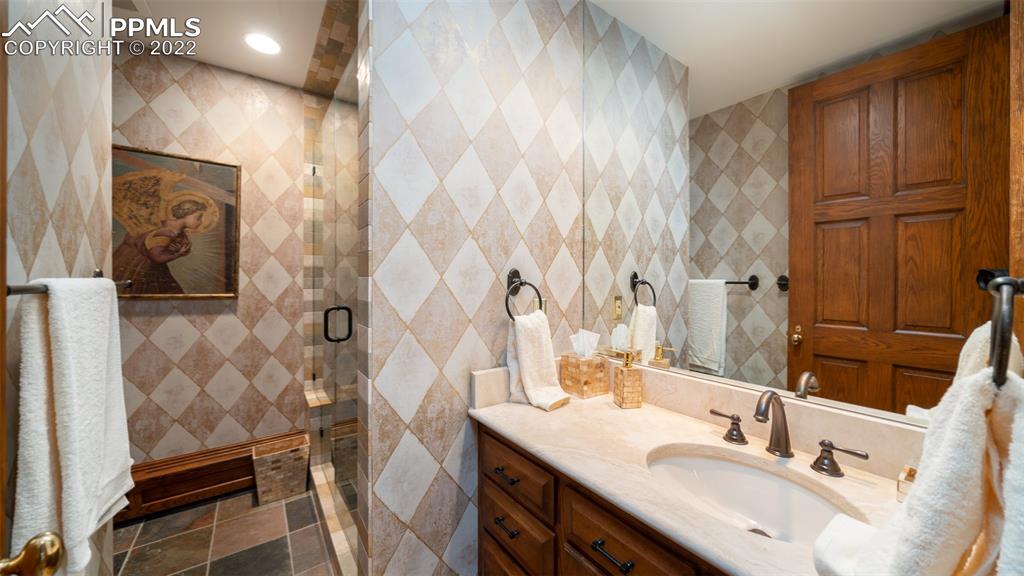 105 Marland Road Colorado Springs, CO 80906 - Photo 39 of 50 a bathroom with a sink vanity granite and a mirror