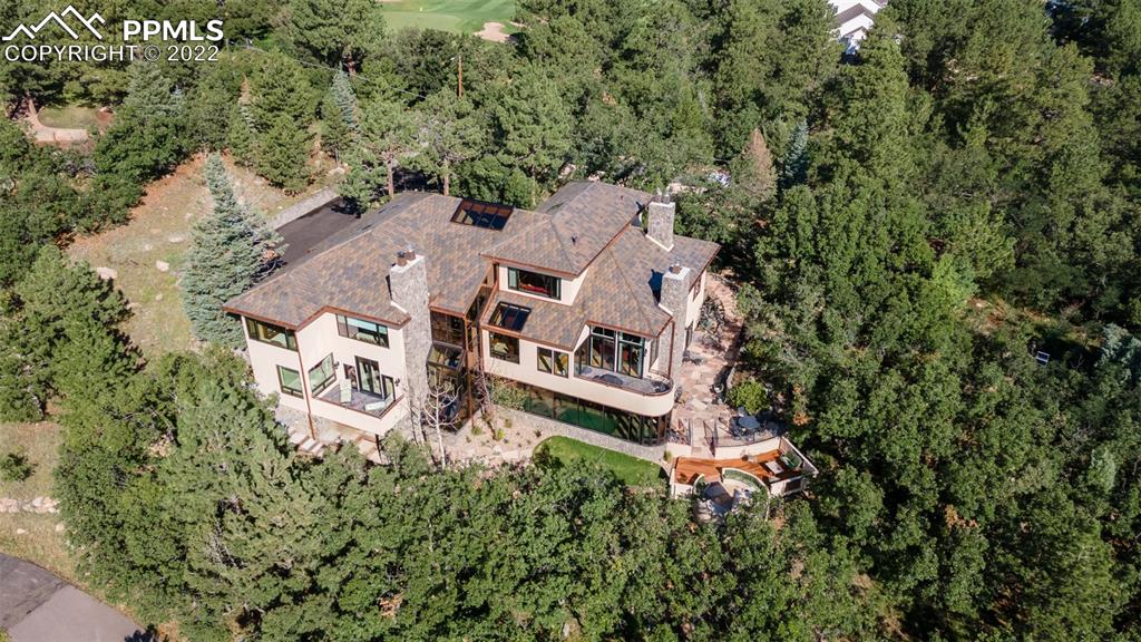 105 Marland Road Colorado Springs, CO 80906 - Photo 47 of 50 an aerial view of a house with outdoor space and trees all around