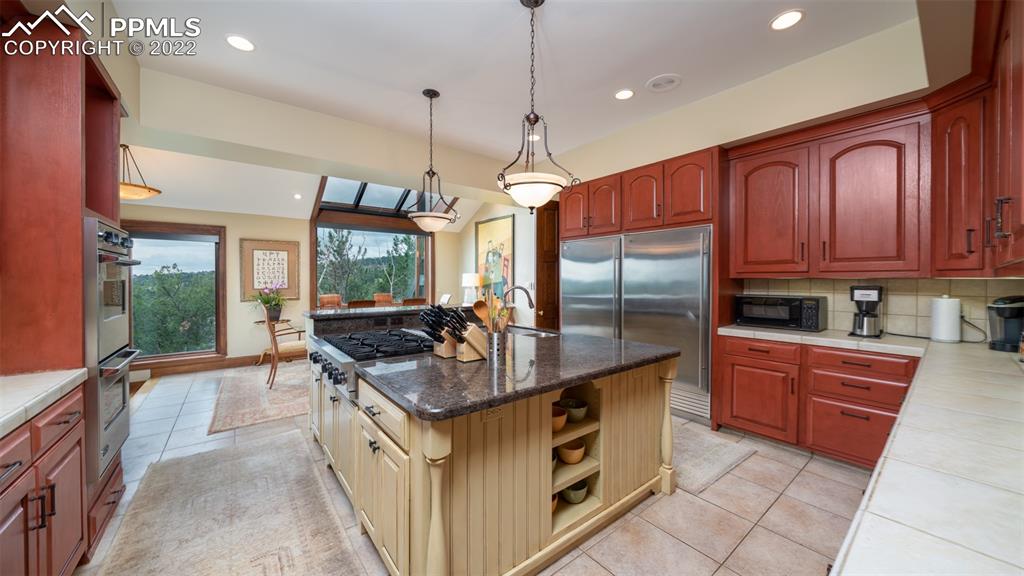 105 Marland Road Colorado Springs, CO 80906 - Photo 8 of 50 a kitchen with stainless steel appliances granite countertop a stove a sink and a refrigerator