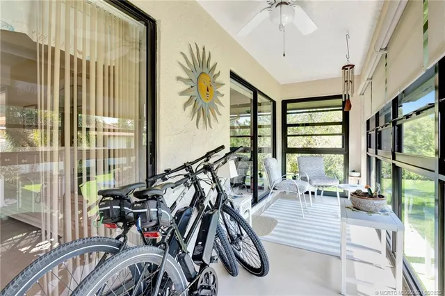 a living room with furniture a rug and a book shelf