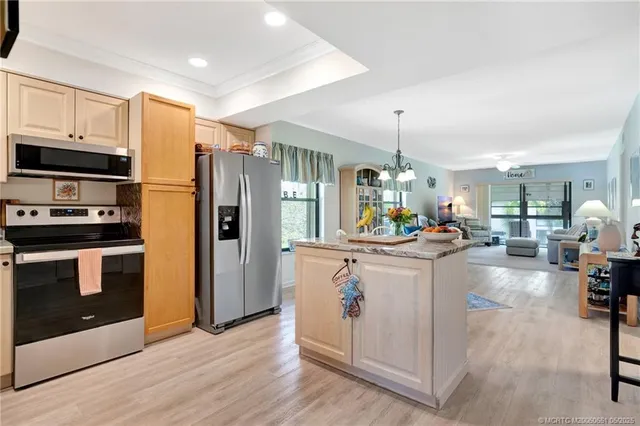 a kitchen with a refrigerator a sink and cabinets