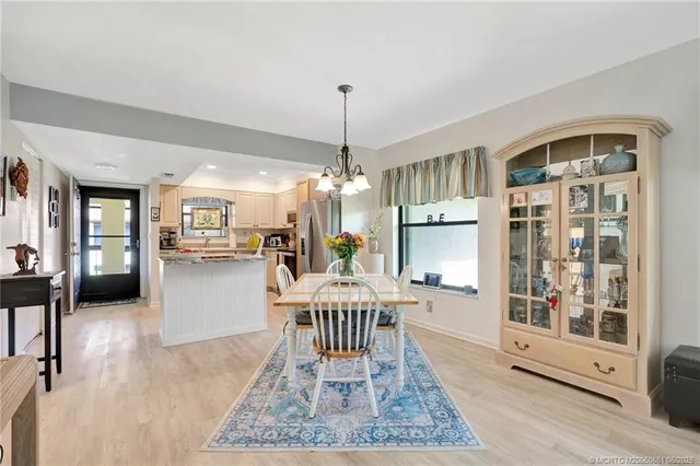 a view of a dining room with furniture and chandelier