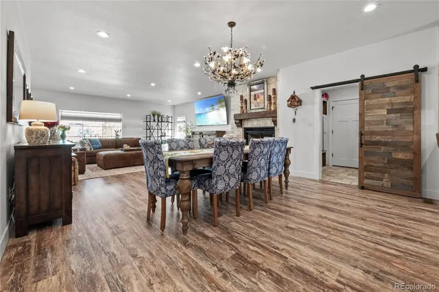 a view of a dining room with furniture and chandelier