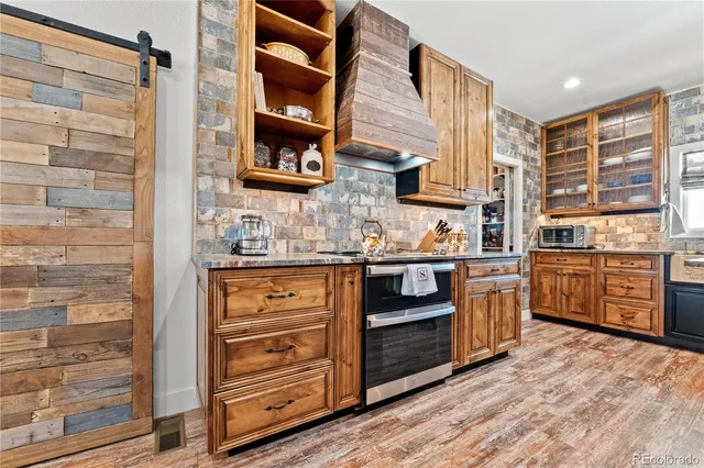a kitchen with stainless steel appliances granite countertop a stove and a sink