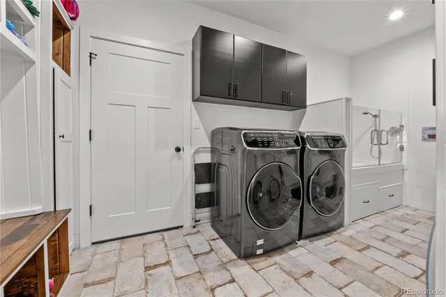 a utility room with sink dryer and washer