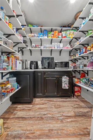 a kitchen with lots of clutter and cabinets