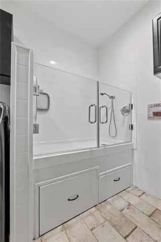 a bathroom with a bathtub and shower