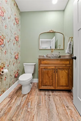 a bathroom with a toilet a sink and mirror