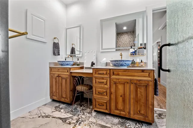 a bathroom with a sink a vanity and a mirror