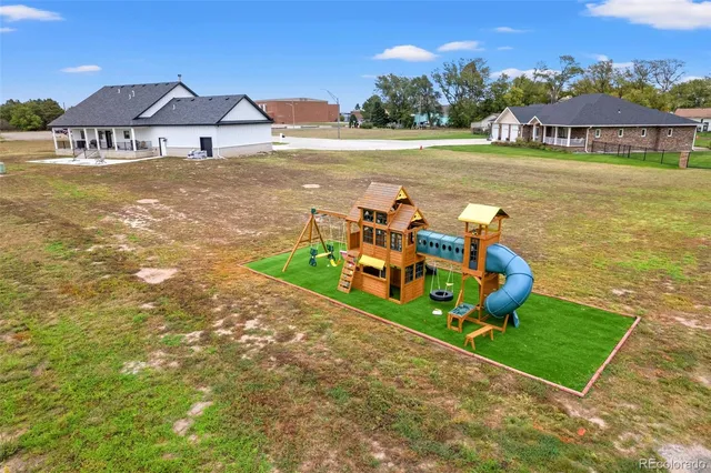 an aerial view of a house with swimming pool garden and patio