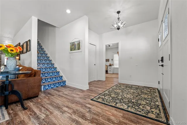 wooden floor in an empty room with a rug