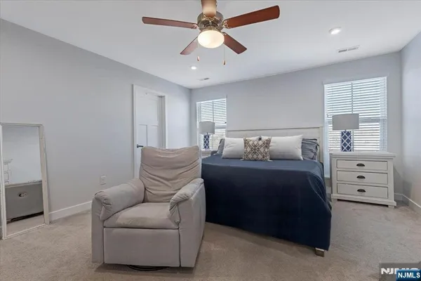 a bedroom with a bed and ceiling fan