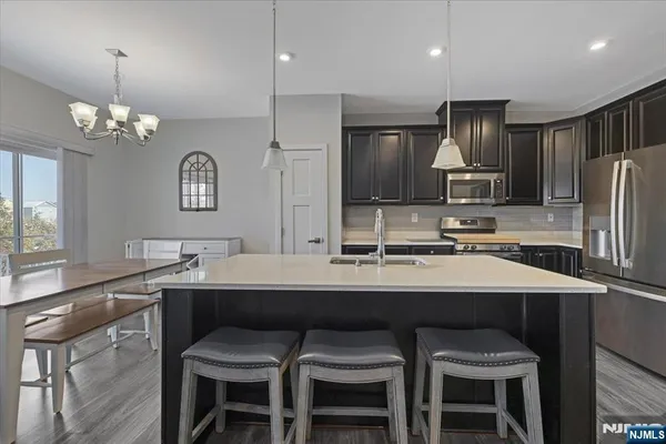 a kitchen with counter space a sink and chairs