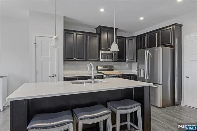 a kitchen with a table chairs refrigerator and microwave