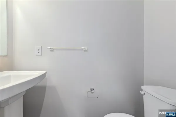 a bathroom with a sink a toilet and a mirror