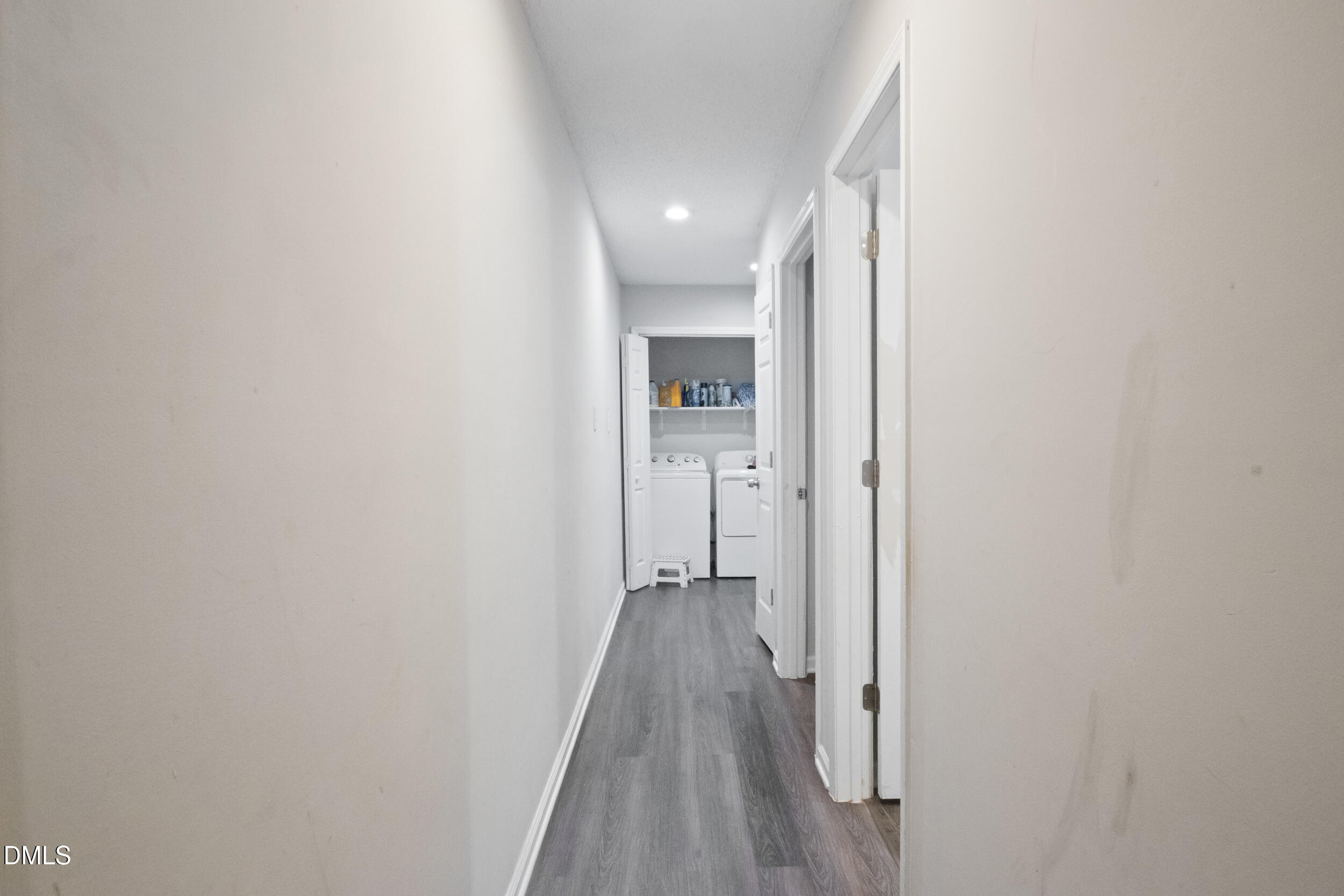 2930 Thomas Road Henderson, NC 27537 - Photo 6 of 17 a view of a hallway with wooden floor and a bathroom