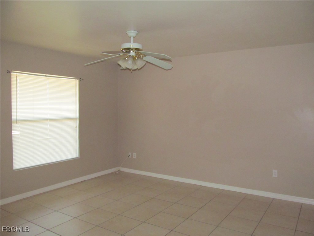 662 Alabama Road South Lehigh Acres, FL 33974 - Photo 4 of 11 an empty room with a window