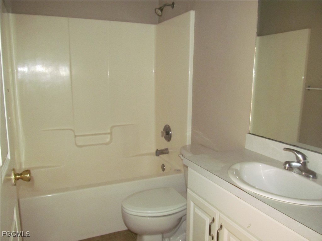 662 Alabama Road South Lehigh Acres, FL 33974 - Photo 6 of 11 a bathroom with a sink a toilet and shower