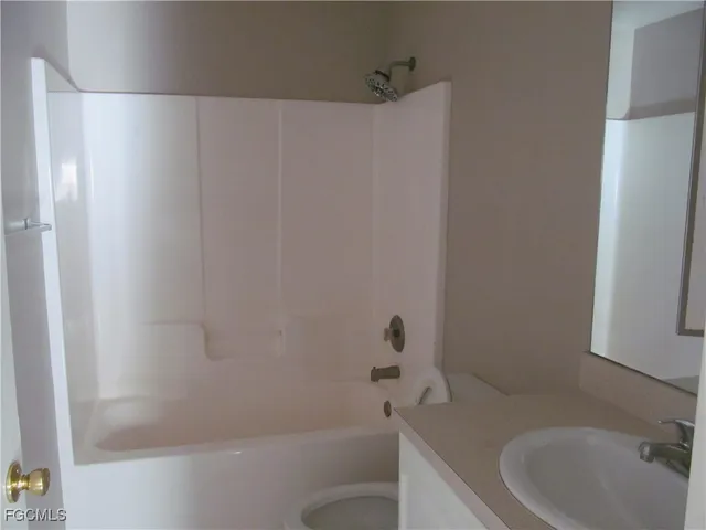 a view of a bathroom with a tub and mirror