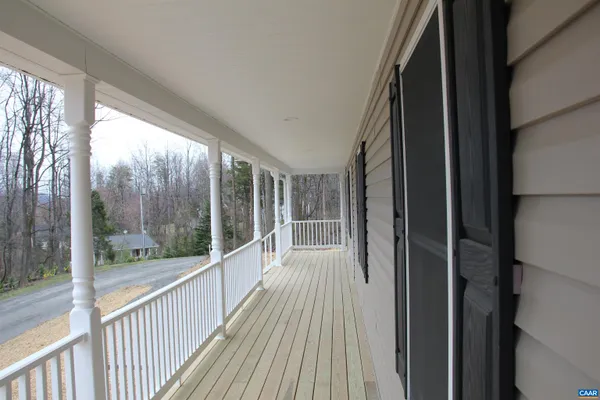 a view of a balcony with wooden floor