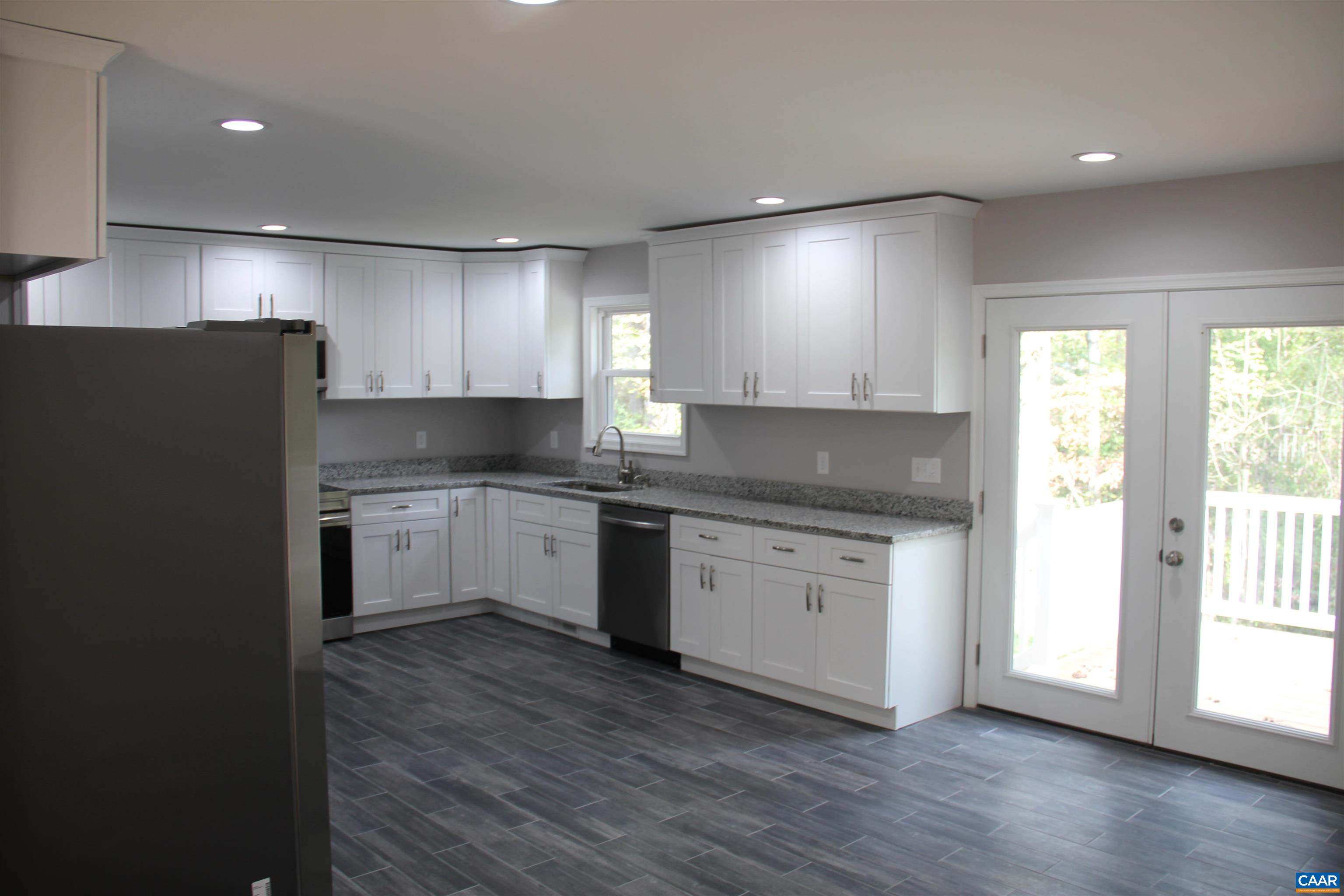 672 Westwood Road Stanardsville, VA 22973 - Photo 13 of 31 a kitchen with granite countertop white cabinets and white appliances