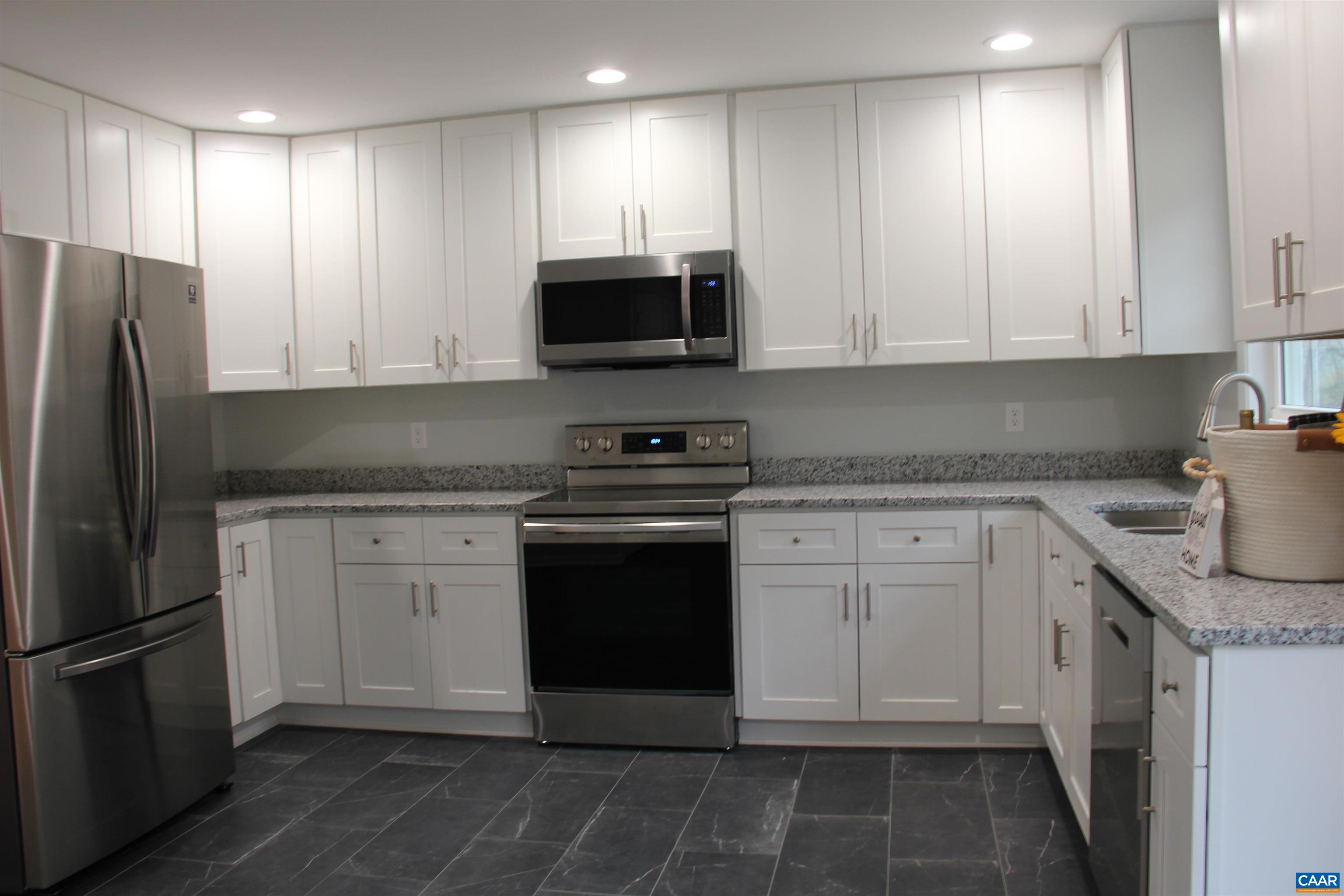 672 Westwood Road Stanardsville, VA 22973 - Photo 14 of 31 a kitchen with stainless steel appliances granite countertop a refrigerator sink and cabinets