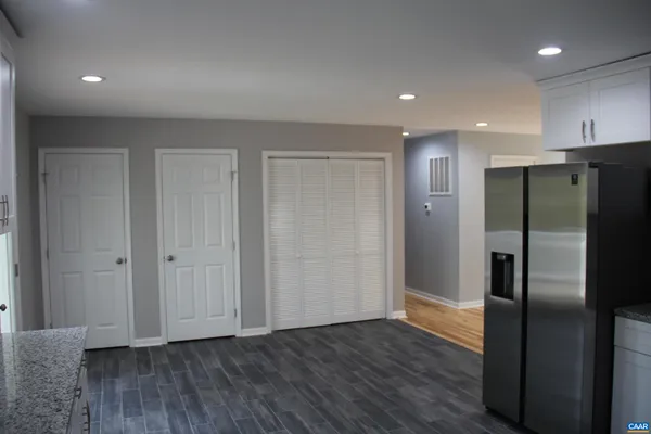 a view of a refrigerator in kitchen and wooden floor