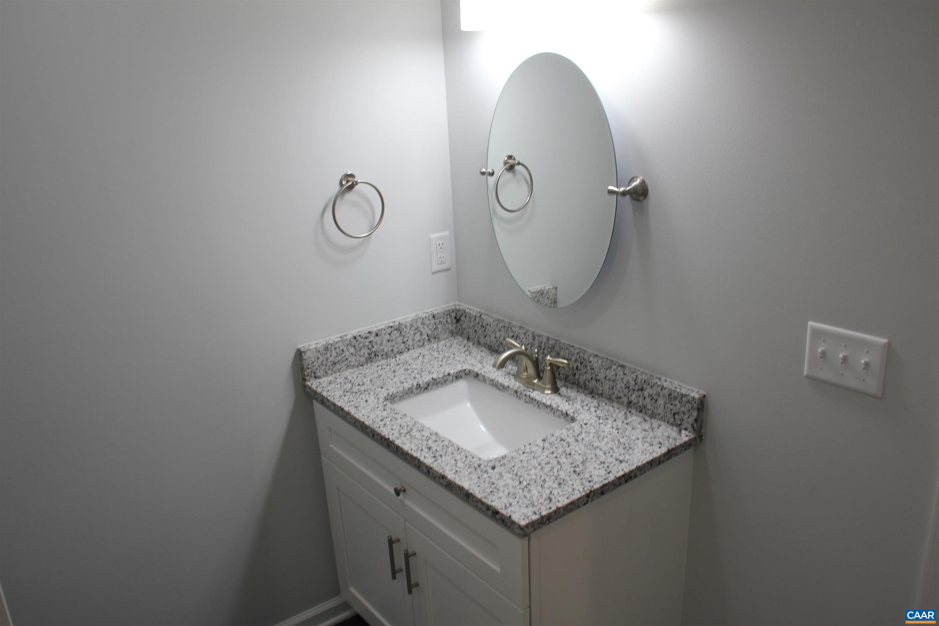 672 Westwood Road Stanardsville, VA 22973 - Photo 29 of 31 a bathroom with a granite countertop sink and a mirror