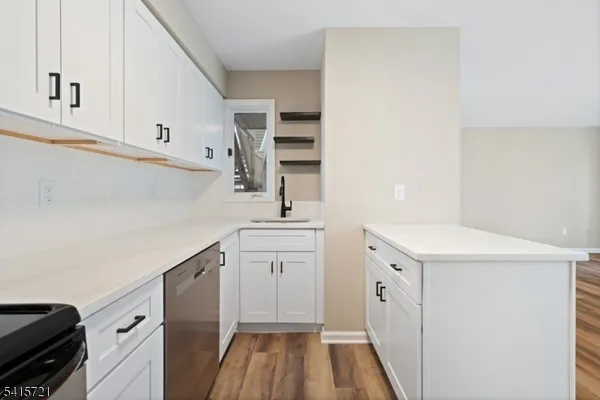 a utility room with cabinets washer and dryer