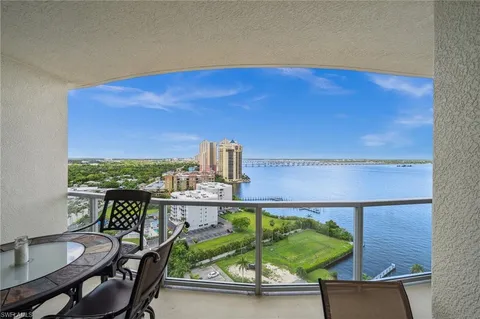 a view of a balcony with chair and wooden floor