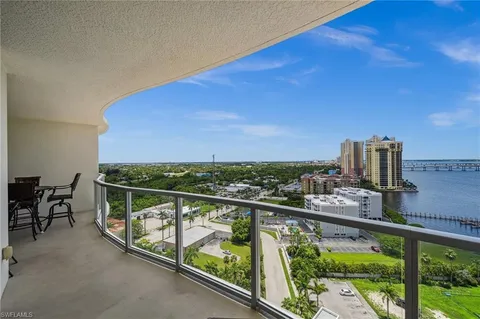 a view of city from a balcony with wooden floor